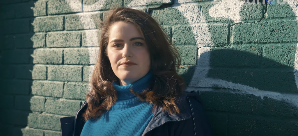 An image of Danya Ateya in front of a brick wall