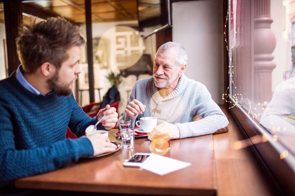 Illustrative image of two people talking over coffee