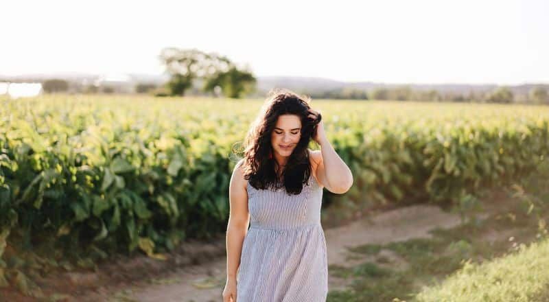 Illustrative image of a person standing in a windy field.