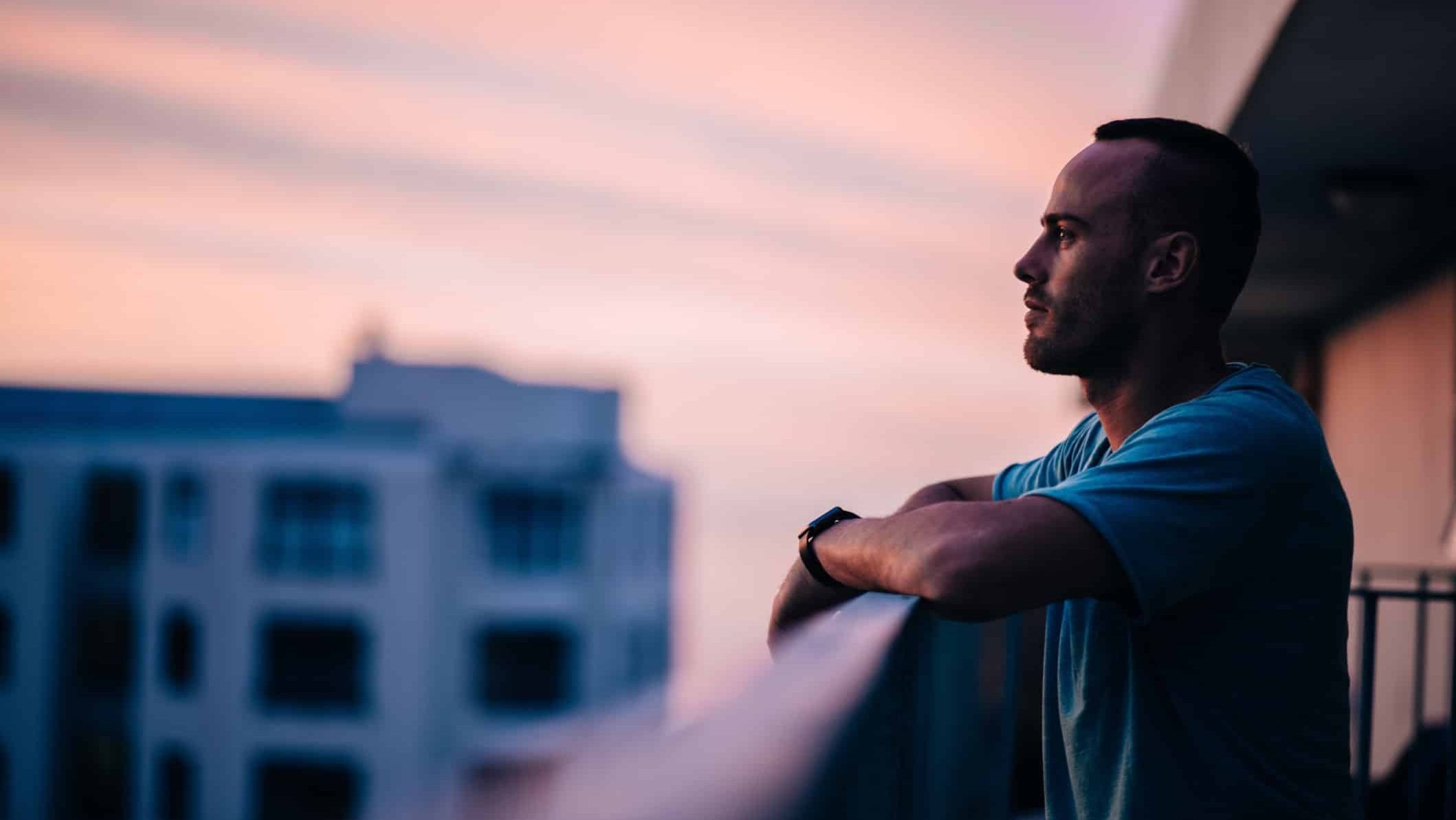 Illustrative image of a person enjoying the view from a balcony.