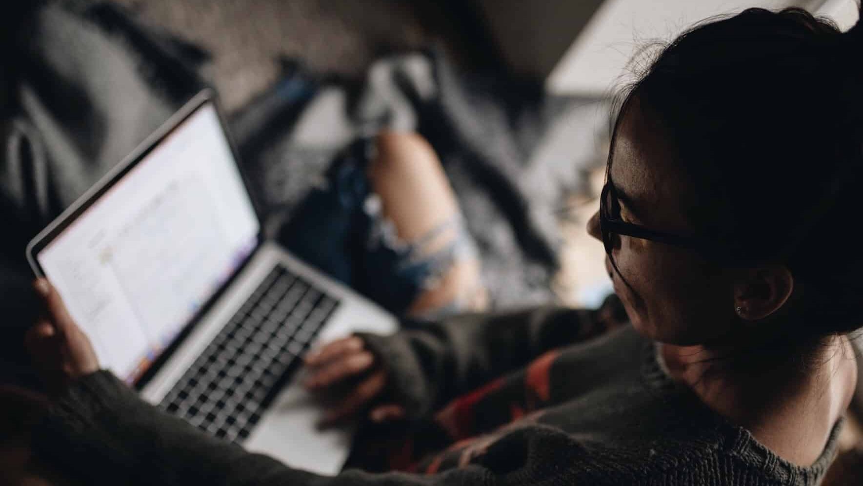 Illustrative image of a person using their laptop.