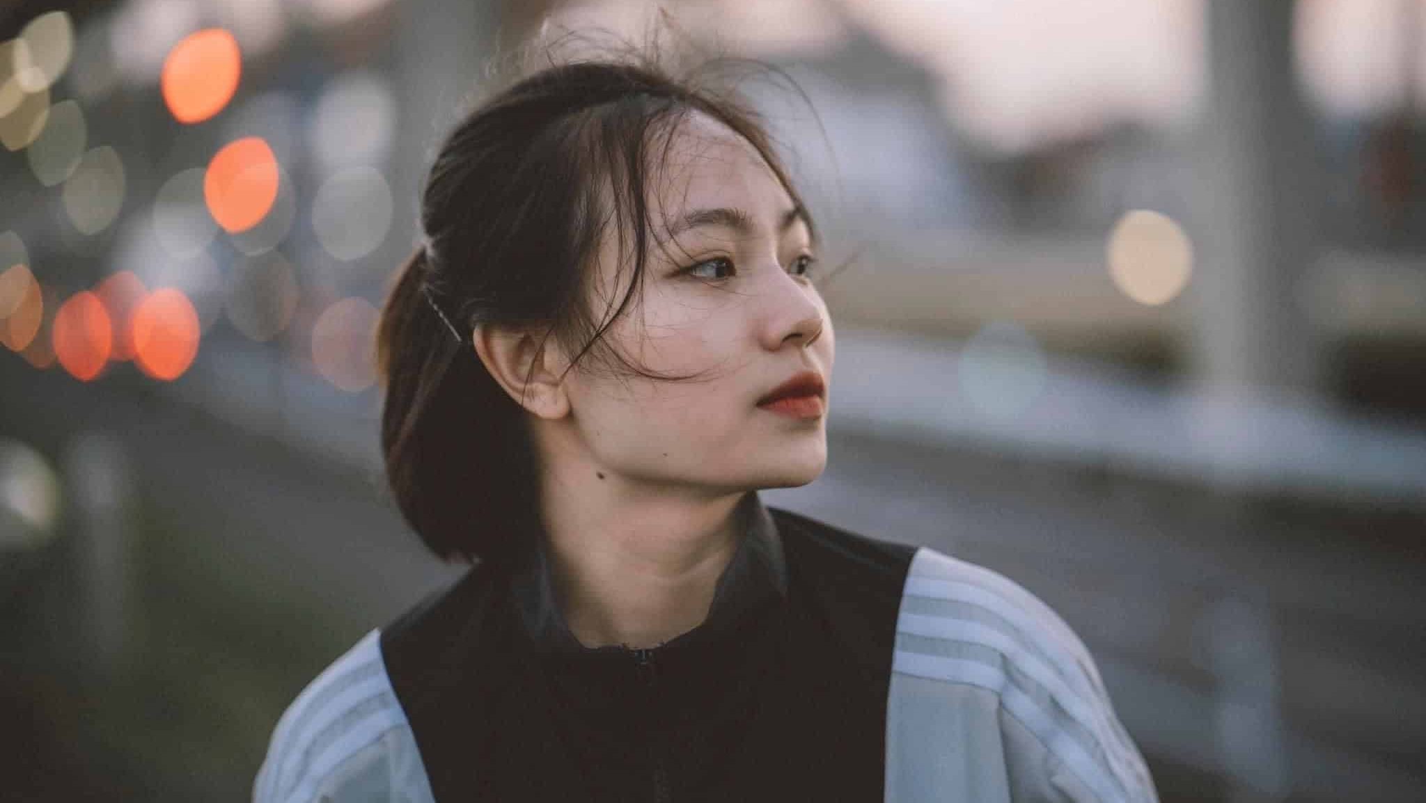 Illustrative image of a person looking into the distance thoughtfully in an outdoor setting.