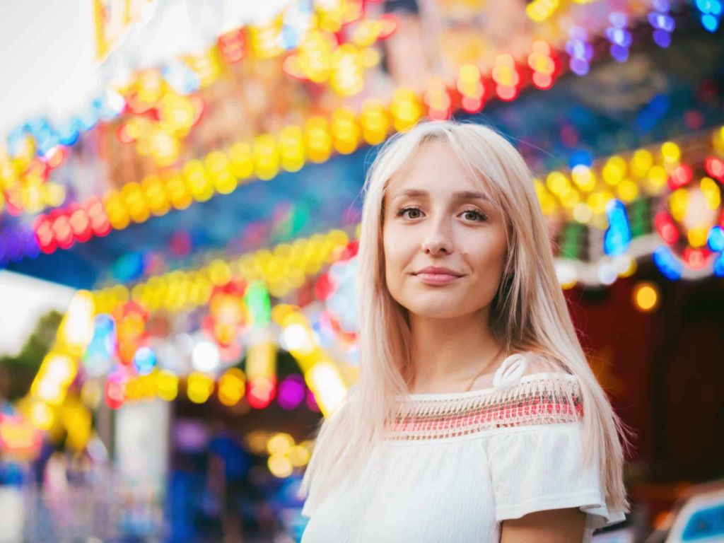 Illustrative image of a person looking confidently into the camera against a blurred colourful background.