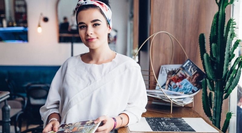 Illustrative image of a person smiling while holding a magazine.