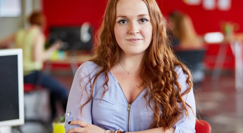 Illustrative image of a calm person with headphones sitting cross-legged on a bed.