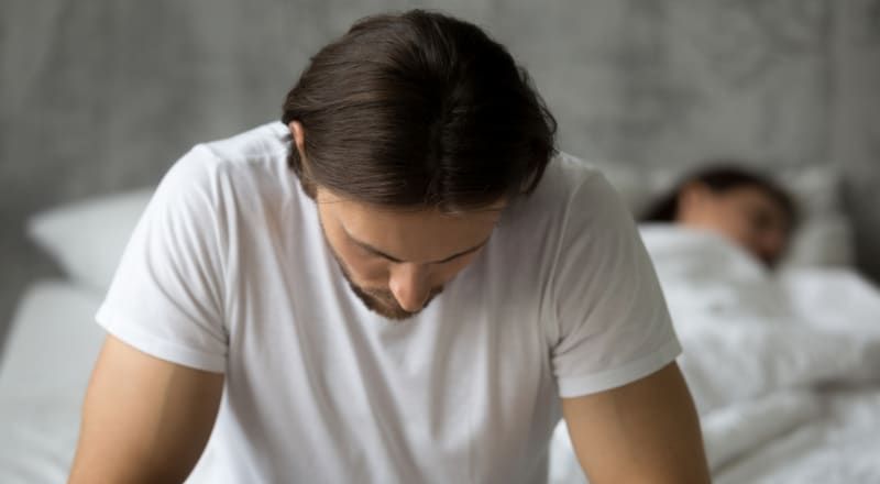 Illustrative image of 6 different hands pointing towards a sad person with back turned and head bowed.