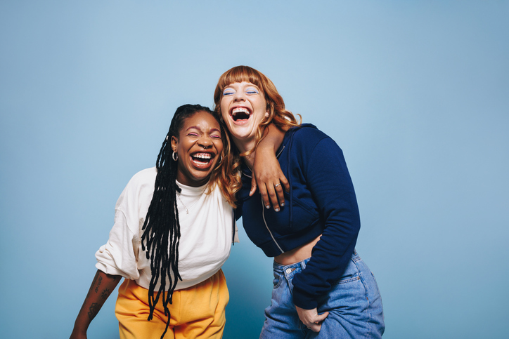 Illustrative image of two people laughing and having a good time together.