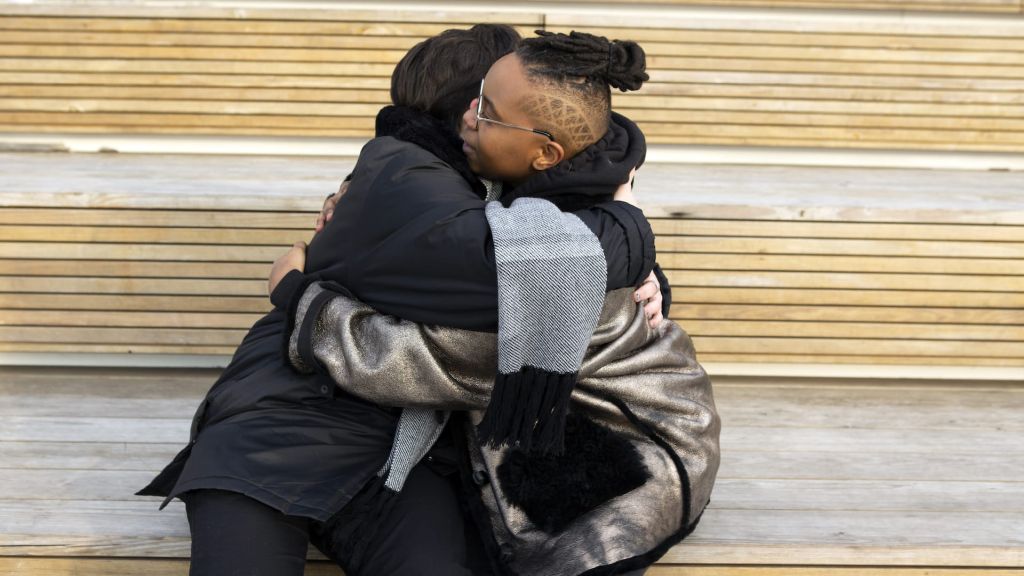 Illustrative image of two people hugging.