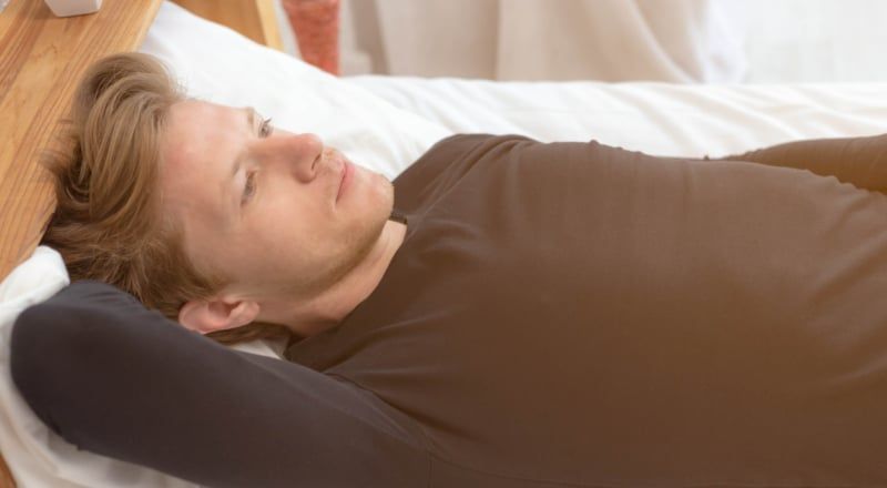 Illustration of a silhouette with lots of abstract shapes representing thoughts in a cloud above the head.