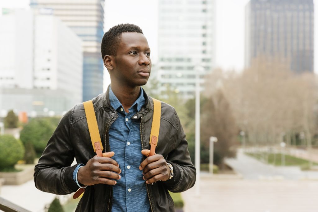 Illustrative image of a person smiling and raising both fists to celebrate their own strength.