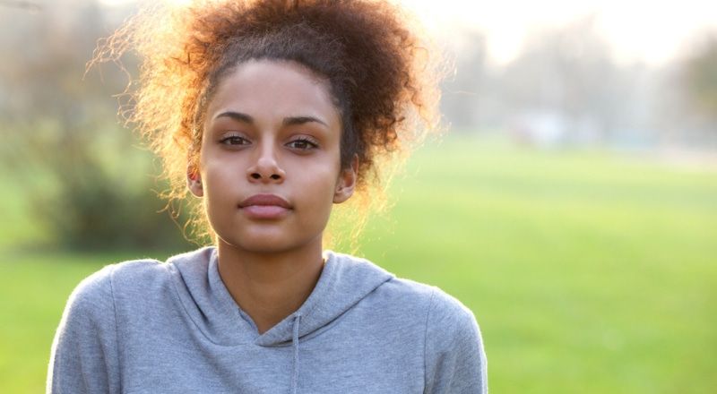 Illustrative image of a person standing in a grassy field.