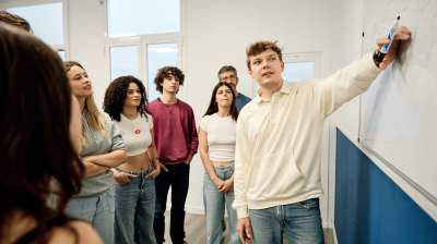 person presenting with classmates watching