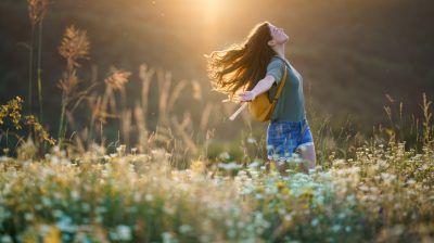 Illustrative image of a happy person in a wildflower meadow.