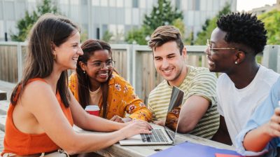 Illustrative image of a group of people smiling and interacting outside.