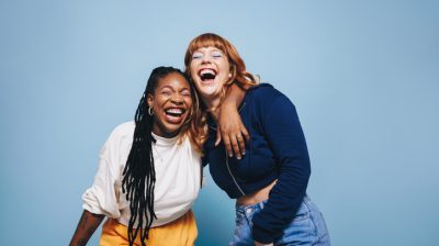 Illustrative image of two people laughing and having a good time together.