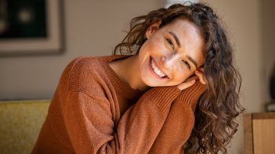 Illustrative image of a person smiling at home.