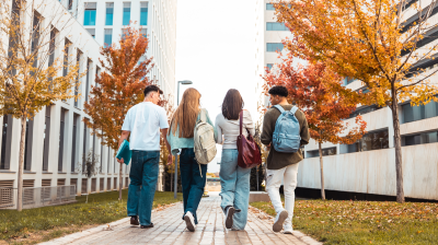 Group of students walking with backpacks on campus