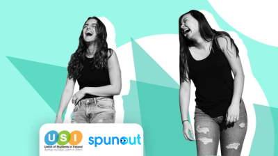 two girls laughing while walking