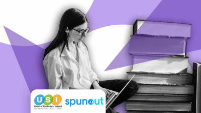 girl studying on a laptop with books