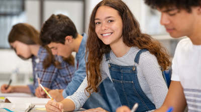 a group of people studying with one smiling at the camera