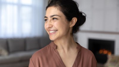 Illustrative image of a person smiling in a cosy indoor setting.