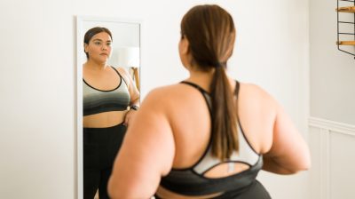 Illustrative image of a person looking into a mirror.