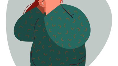 Illustrative image of a person crying with hands raised to their face.