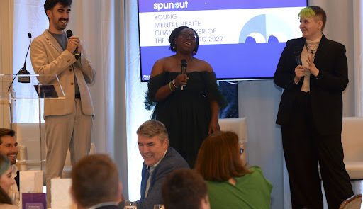 Three people presenting standing in front of a spunout presentation - one is Joseph Morning, spunout staff memeber
