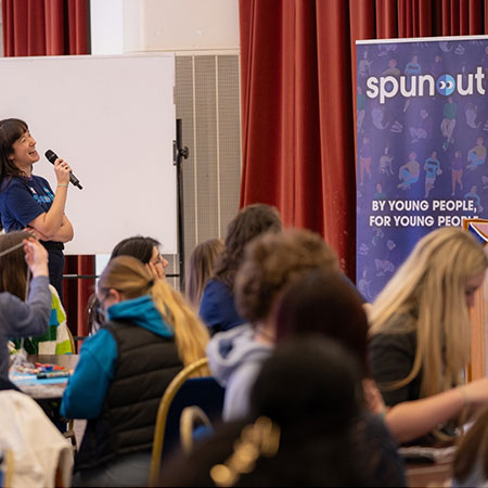 A spunout staff memeber speaking to a crowd