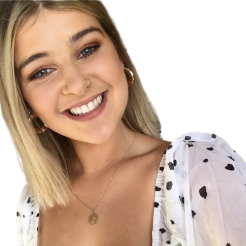 Aisling smiles at camera in polka dot top
