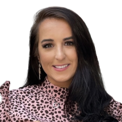 Alyss smiles at camera in cheeta print top.