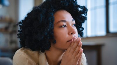 Pensive person looking off into the distance.