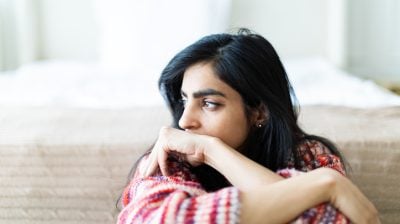 Illustrative image of a person looking off to the side with a sad expression.