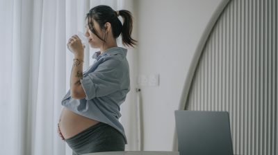asian chinese young pregnant woman at home drinking water