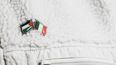palestine and irish lapel flags on persons jacket