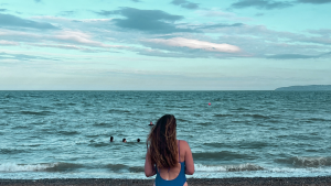 Swimmer standing infront of the sea