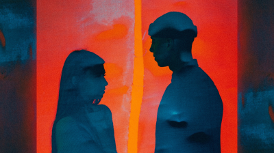 Silhoutte of two people facing each other painted on a red background