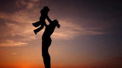 Parent lifting child in the air