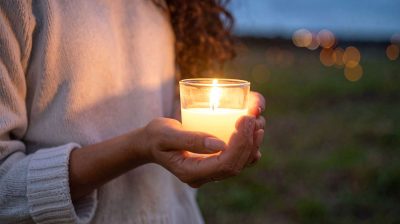 Hand holding a candle