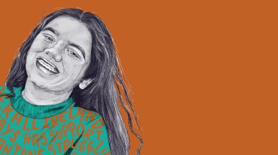 Ishita, portrait of feminine presenting person smiling against an orange background