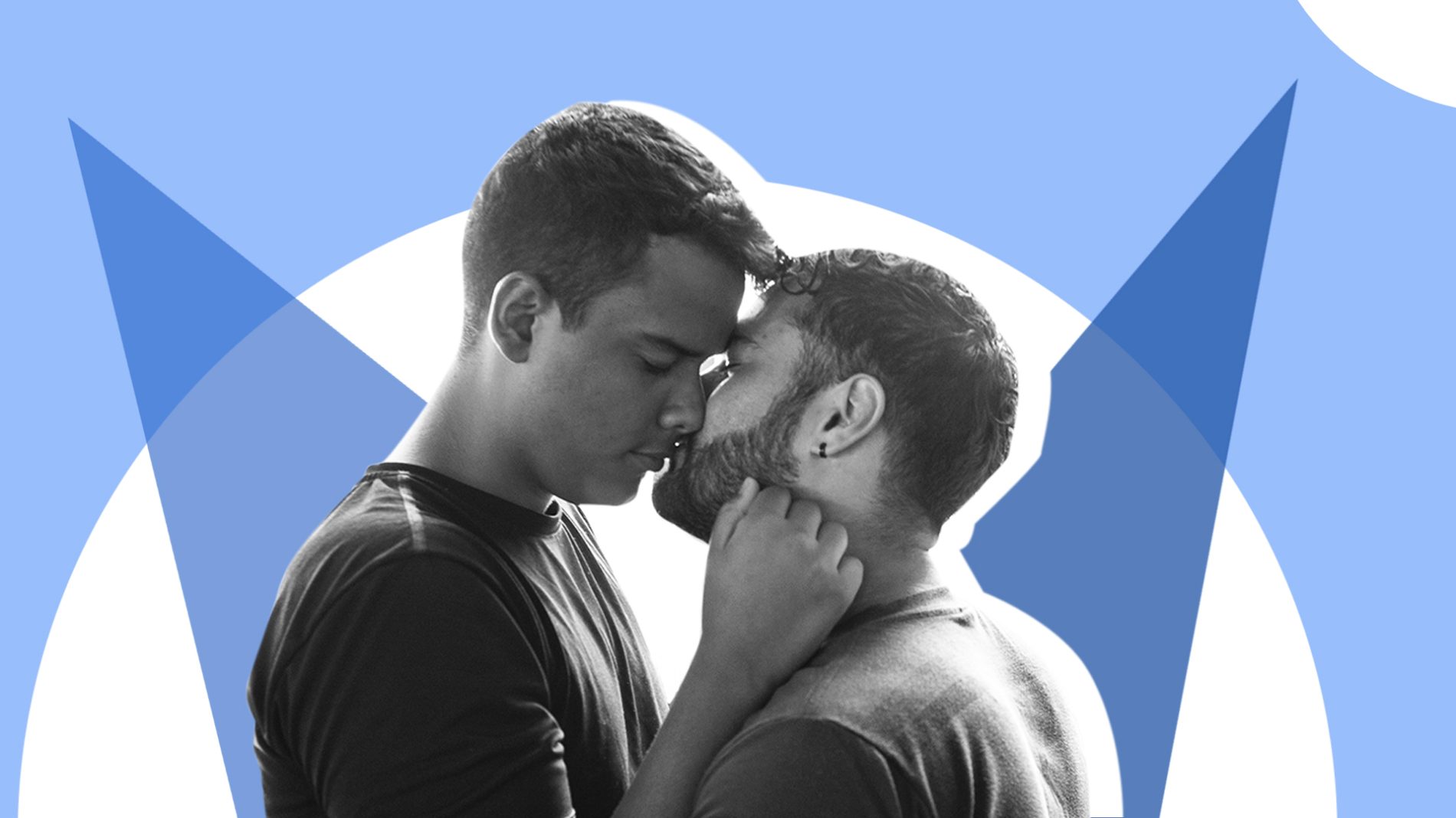 Two young men kissing in front of a blue and white background