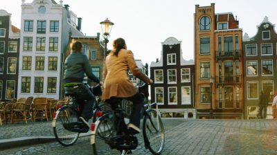 Couple riding bicycles, rear veiw (blurred motion)
