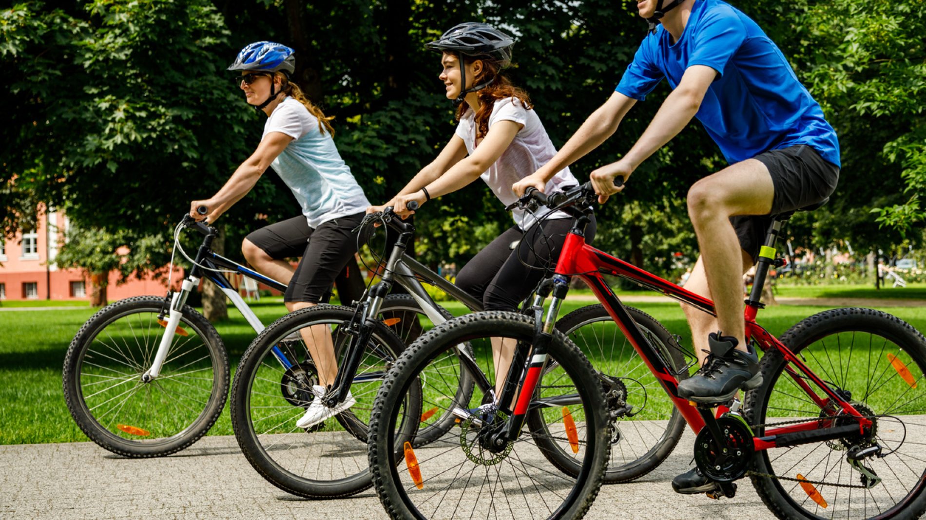 Urban biking- three people riding bikes in city