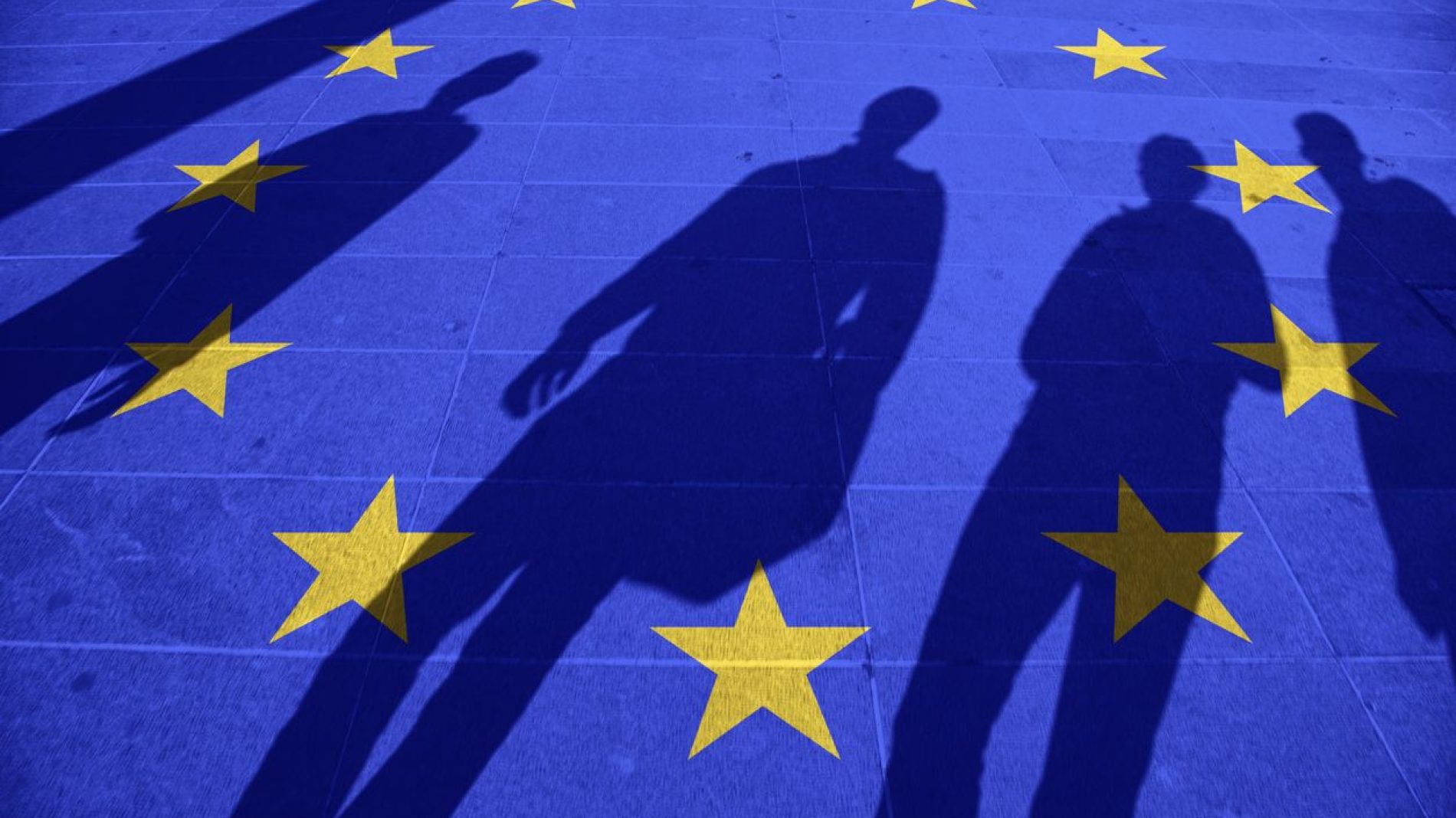 Shadows standing over the EU flag