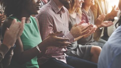 Group of people clapping during an event