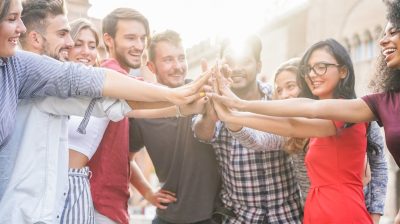 A group of young people with their hands together
