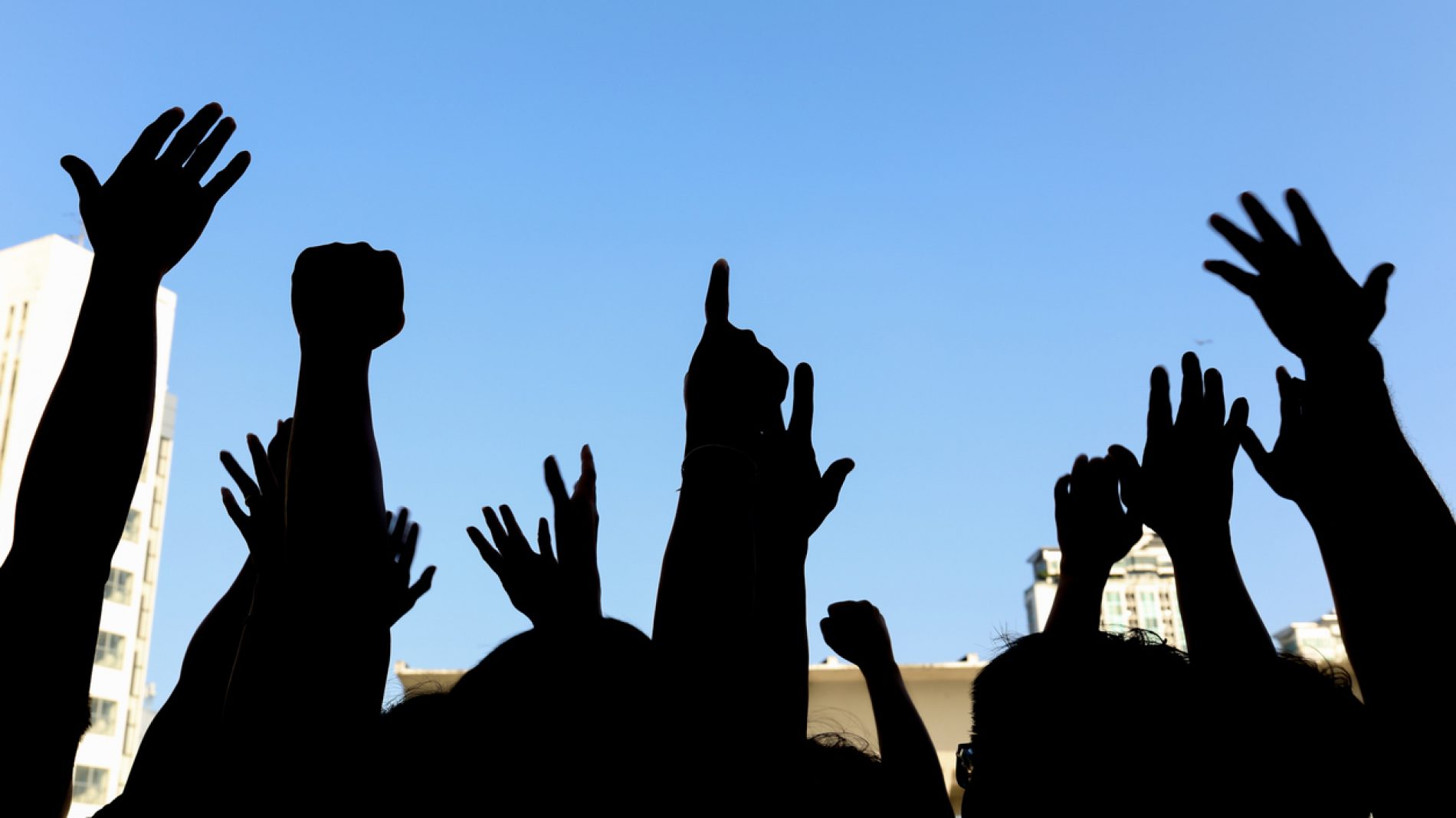 community initiative or concert concept, hands of group of people in the sky, silhouette