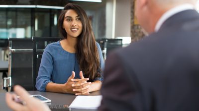 Smiling female client talking to male manager