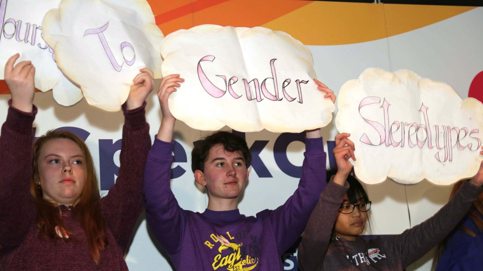 Students from Maryfield College hold up signs against gender stereotypes