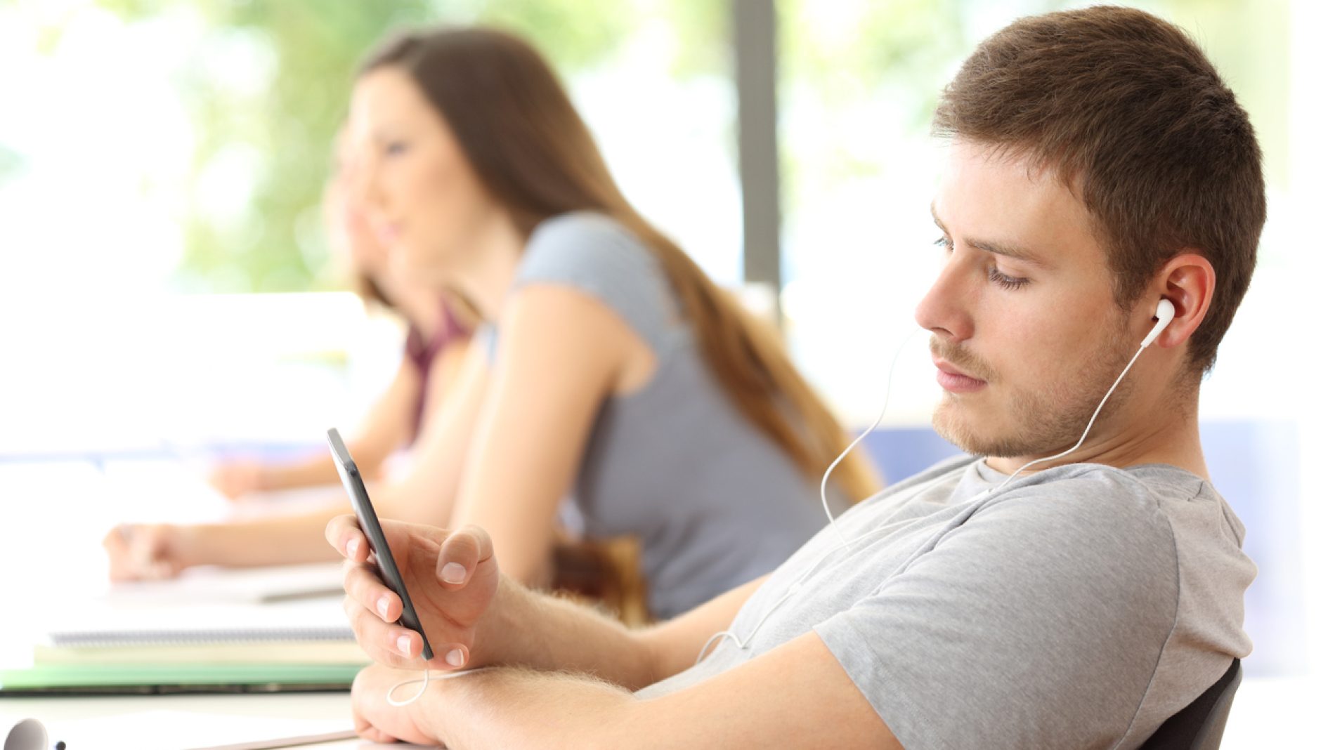Bad student distracted listening music in classroom